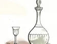A wine glass beside a clear glass decanter
