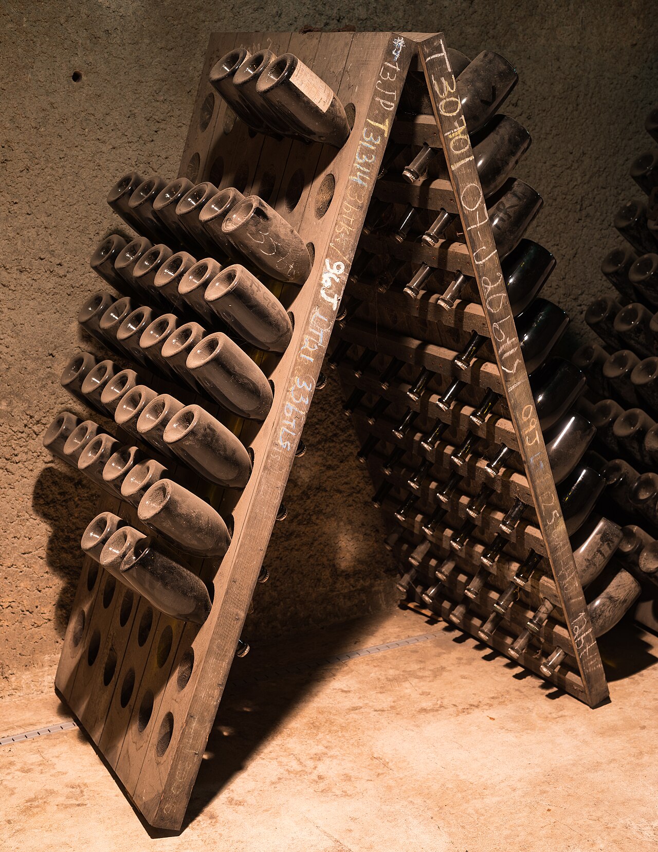 Wine bottles resting in a traditional cellar